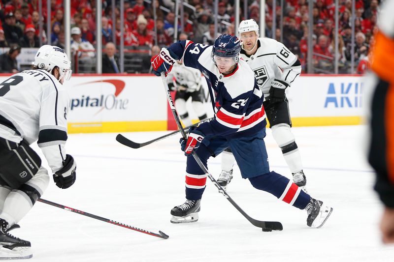 Jan 7, 2024; Washington, District of Columbia, USA; Washington Capitals center Connor McMichael (24) controls the puck in front of Los Angeles Kings center Trevor Lewis (61) and Kings defenseman Drew Doughty (8) during the second period at Capital One Arena. Mandatory Credit: Amber Searls-USA TODAY Sports