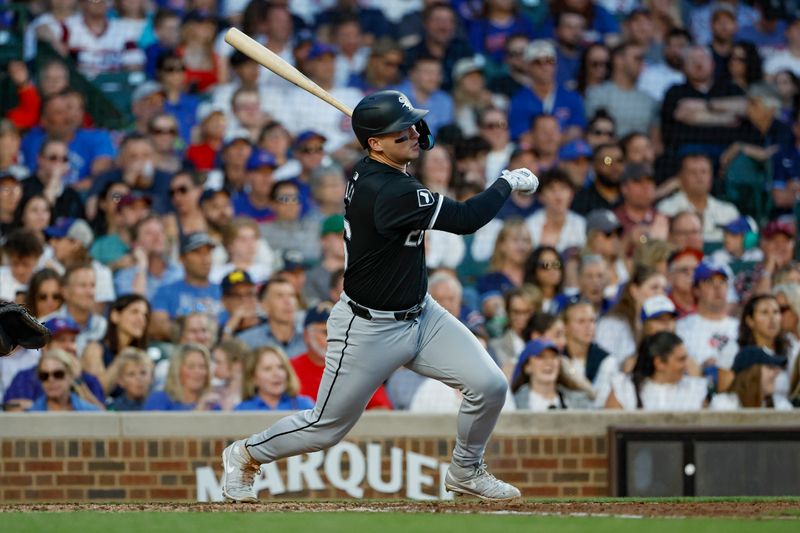 Jun 5, 2024; Chicago, Illinois, USA; Chicago White Sox catcher Korey Lee (26) hits an RBI-single against the Chicago Cubs during the fourth inning at Wrigley Field. Mandatory Credit: Kamil Krzaczynski-USA TODAY Sports
