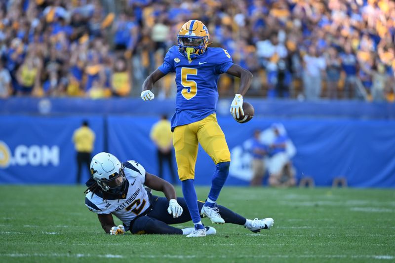 Sep 14, 2024; Pittsburgh, Pennsylvania, USA; Pittsburgh Panthers wide receiver Raphael Williams Jr. (5) celebrates after a catch against West Virginia Mountaineers safety Aubrey Burks (2) during the second quarter at Acrisure Stadium. Mandatory Credit: Barry Reeger-Image Images