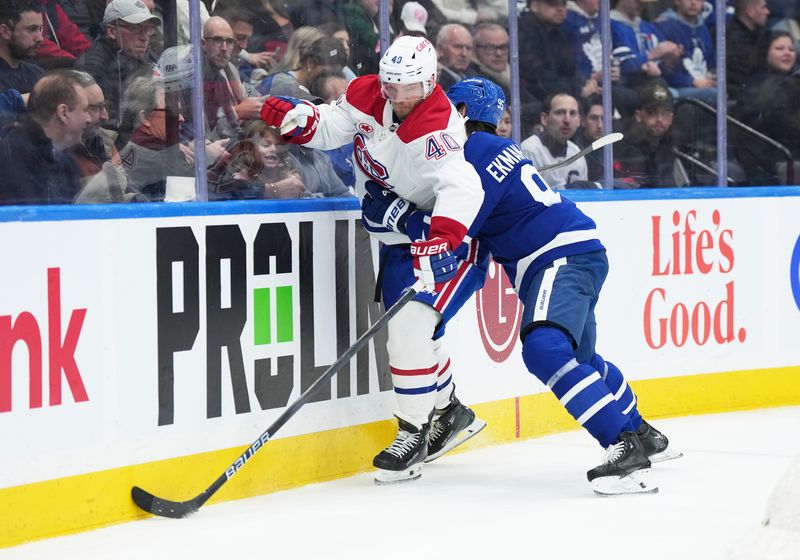 Nov 9, 2024; Toronto, Ontario, CAN; Montreal Canadiens right wing Joel Armia (40) battles along the boards with Toronto Maple Leafs defenseman Oliver Ekman-Larsson (95) during the second period at Scotiabank Arena. Mandatory Credit: Nick Turchiaro-Imagn Images