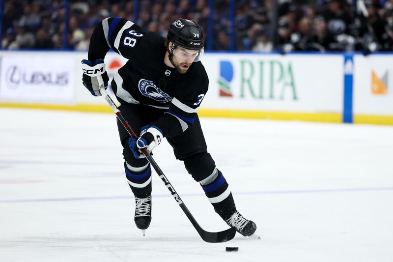 Feb 17, 2024; Tampa, Florida, USA;  Tampa Bay Lightning left wing Brandon Hagel (38) controls the puck against the Florida Panthers in the third period at Amalie Arena. Mandatory Credit: Nathan Ray Seebeck-USA TODAY Sports