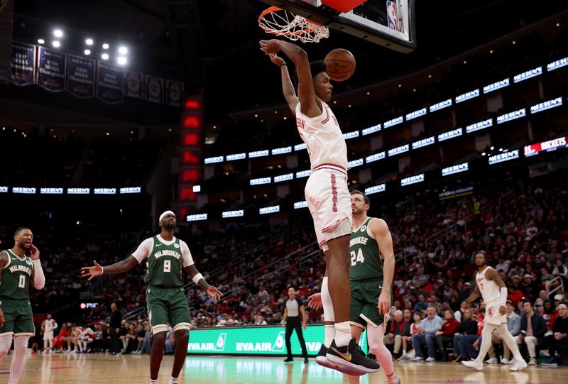 HOUSTON, TEXAS - JANUARY 06: Amen Thompson #1 of the Houston Rockets dunks the ball in the first half against the Milwaukee Bucks at Toyota Center on January 06, 2024 in Houston, Texas.  NOTE TO USER: User expressly acknowledges and agrees that, by downloading and or using this photograph, User is consenting to the terms and conditions of the Getty Images License Agreement. (Photo by Tim Warner/Getty Images)