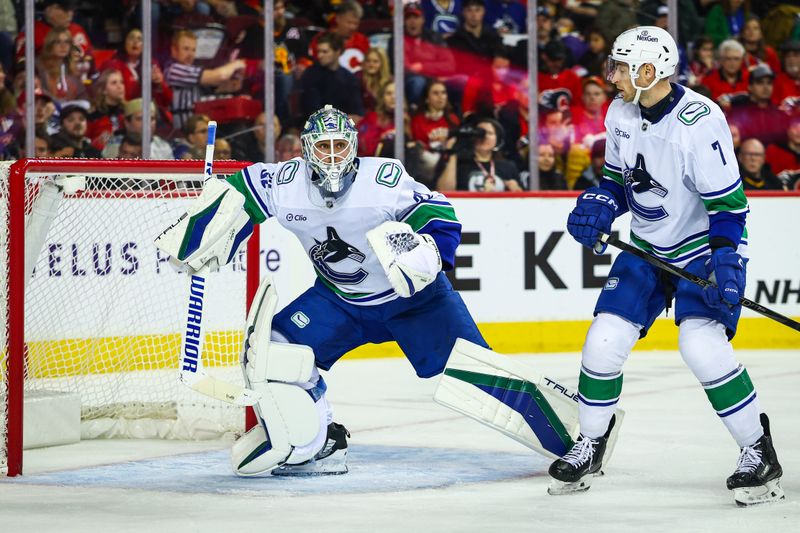 Dec 31, 2024; Calgary, Alberta, CAN; Vancouver Canucks goaltender Kevin Lankinen (32) guards his net against the Calgary Flames during the second period at Scotiabank Saddledome. Mandatory Credit: Sergei Belski-Imagn Images