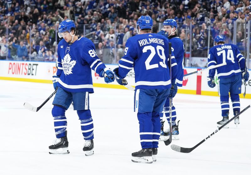 Feb 17, 2024; Toronto, Ontario, CAN; Toronto Maple Leafs left wing Nicholas Robertson (89) scores a goal and celebrates with right wing Pontus Holmberg (29) against the Anaheim Ducks during the third period at Scotiabank Arena. Mandatory Credit: Nick Turchiaro-USA TODAY Sports