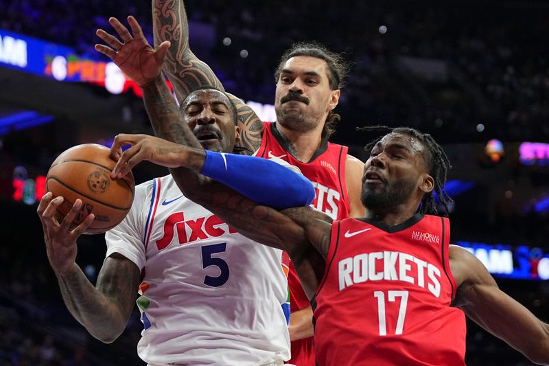 PHILADELPHIA, PENNSYLVANIA - NOVEMBER 27: Andre Drummond #5 of the Philadelphia 76ers grabs a rebound against Steven Adams #12 and Tari Eason #17 of the Houston Rockets in the first half at the Wells Fargo Center on November 27, 2024 in Philadelphia, Pennsylvania. NOTE TO USER: User expressly acknowledges and agrees that, by downloading and/or using this photograph, user is consenting to the terms and conditions of the Getty Images License Agreement. (Photo by Mitchell Leff/Getty Images)