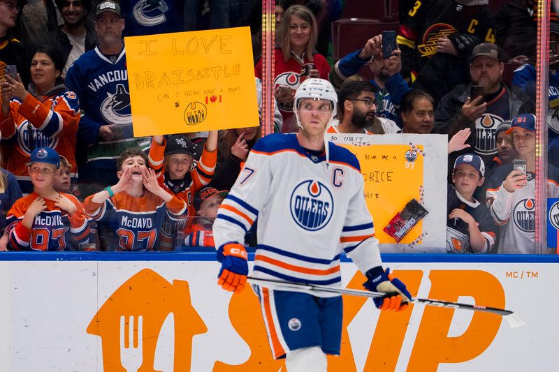 Nov 6, 2023; Vancouver, British Columbia, CAN; Young fans cheer on Edmonton Oilers forward Connor McDavid (97) during warm up prior to a game against the Vancouver Canucks at Rogers Arena. Mandatory Credit: Bob Frid-USA TODAY Sports