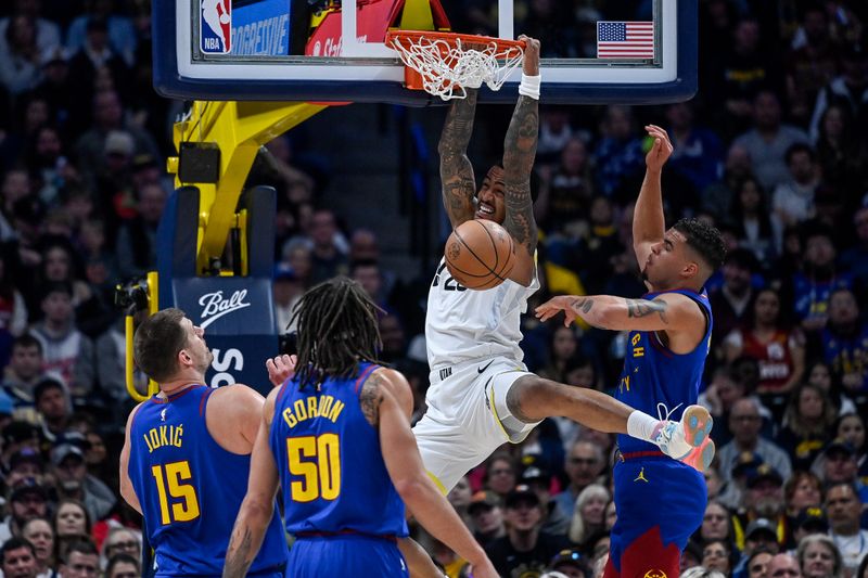 DENVER, COLORADO - MARCH 9: Otto Porter Jr. #22 of the Utah Jazz slams the ball in the first half against the Denver Nuggets at Ball Arena on March 9, 2024 in Denver, Colorado. (Photo by Dustin Bradford/Getty Images)