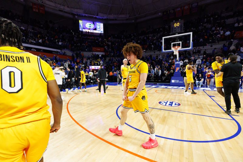 Jan 14, 2025; Gainesville, Florida, USA; Missouri Tigers guard T.O. Barrett (5) celebrates a win with Missouri Tigers guard Anthony Robinson II (0) after a game against the Florida Gators at Exactech Arena at the Stephen C. O'Connell Center. Mandatory Credit: Matt Pendleton-Imagn Images
