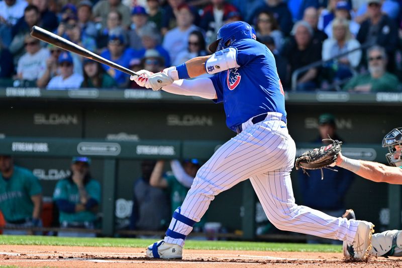 Mar 8, 2024; Mesa, Arizona, USA;  Chicago Cubs right fielder Seiya Suzuki (27) singles in the first inning against the Seattle Mariners during a spring training game at Sloan Park. Mandatory Credit: Matt Kartozian-USA TODAY Sports