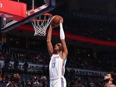 OKLAHOMA CITY, OK - DECEMBER 18:  Ousmane Dieng #13 of the Oklahoma City Thunder dunks the ball during the game against the Memphis Grizzlies on December 18, 2023 at Paycom Arena in Oklahoma City, Oklahoma. NOTE TO USER: User expressly acknowledges and agrees that, by downloading and or using this photograph, User is consenting to the terms and conditions of the Getty Images License Agreement. Mandatory Copyright Notice: Copyright 2023 NBAE (Photo by Zach Beeker/NBAE via Getty Images)