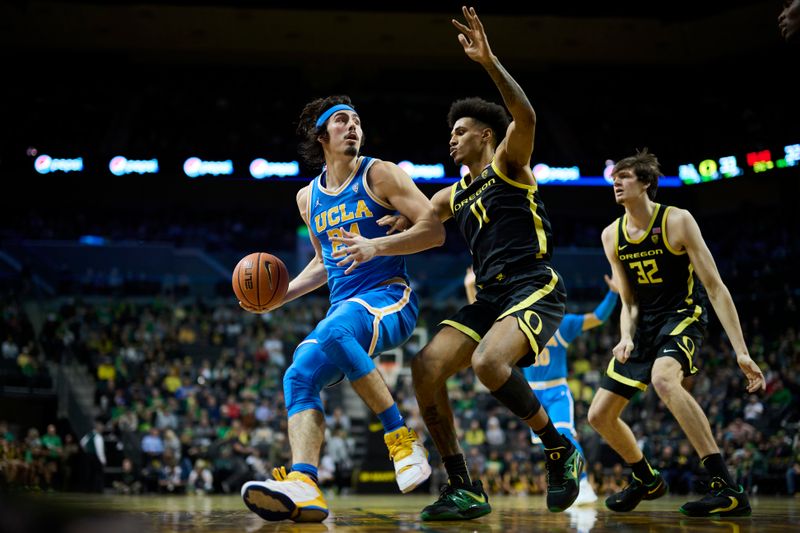 Feb 11, 2023; Eugene, Oregon, USA; UCLA Bruins guard Jaime Jaquez Jr. (24) dribbles the ball during the second half against Oregon Ducks guard Rivaldo Soares (11) at Matthew Knight Arena. Mandatory Credit: Troy Wayrynen-USA TODAY Sports