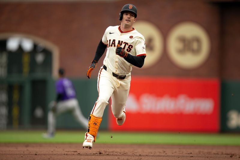 Jul 27, 2024; San Francisco, California, USA; San Francisco Giants right fielder Mike Yastrzemski (5) legs out a triple against the Colorado Rockies during the second inning at Oracle Park. Mandatory Credit: D. Ross Cameron-USA TODAY Sports