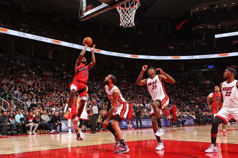 TORONTO, CANADA - JANUARY 17: Immanuel Quickley #5 of the Toronto Raptors drives to the basket during the game against the Miami Heat on January 17, 2024 at the Scotiabank Arena in Toronto, Ontario, Canada.  NOTE TO USER: User expressly acknowledges and agrees that, by downloading and or using this Photograph, user is consenting to the terms and conditions of the Getty Images License Agreement.  Mandatory Copyright Notice: Copyright 2024 NBAE (Photo by Vaughn Ridley/NBAE via Getty Images)