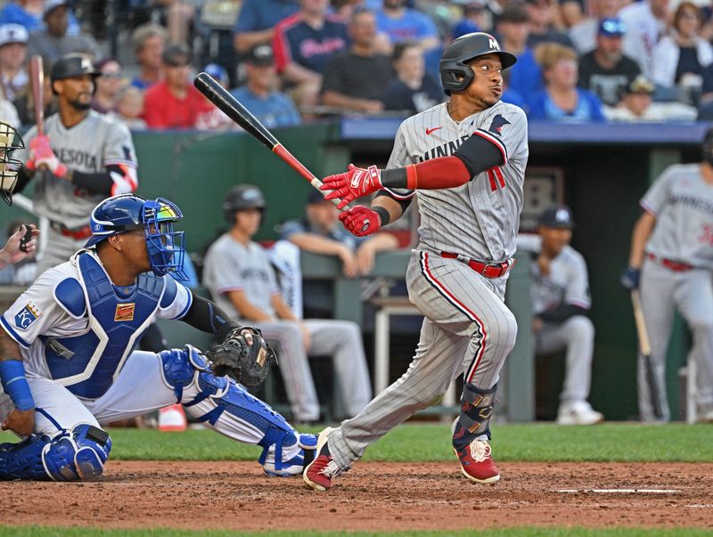 Jul 29, 2023; Kansas City, Missouri, USA;  Minnesota Twins third baseman Jorge Polanco (11) drives in a run against the Kansas City Royals during the fourth inning at Kauffman Stadium. Mandatory Credit: Peter Aiken-USA TODAY Sports