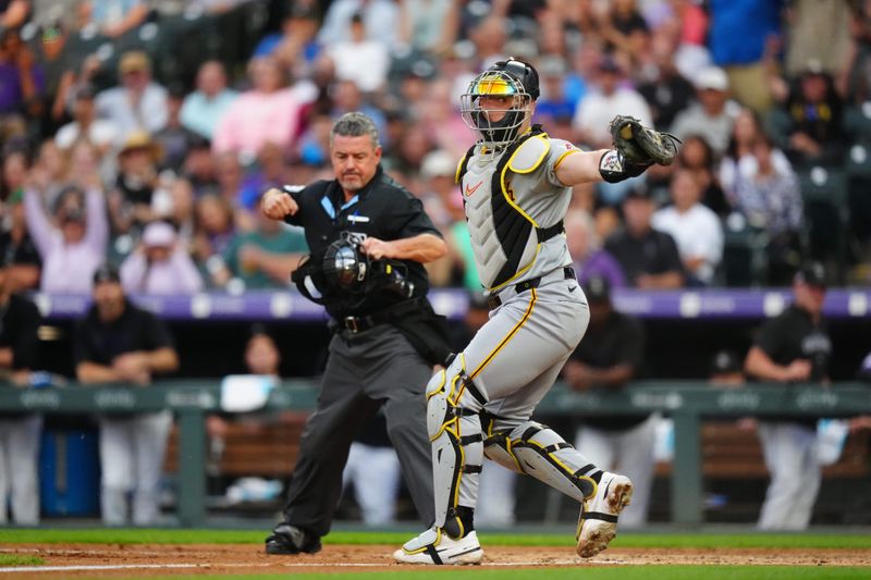 Jun 14, 2024; Denver, Colorado, USA; Pittsburgh Pirates catcher Henry Davis (32) shows off the baseball following a tag out in the sixth inning against the Colorado Rockies at Coors Field. Mandatory Credit: Ron Chenoy-USA TODAY Sports