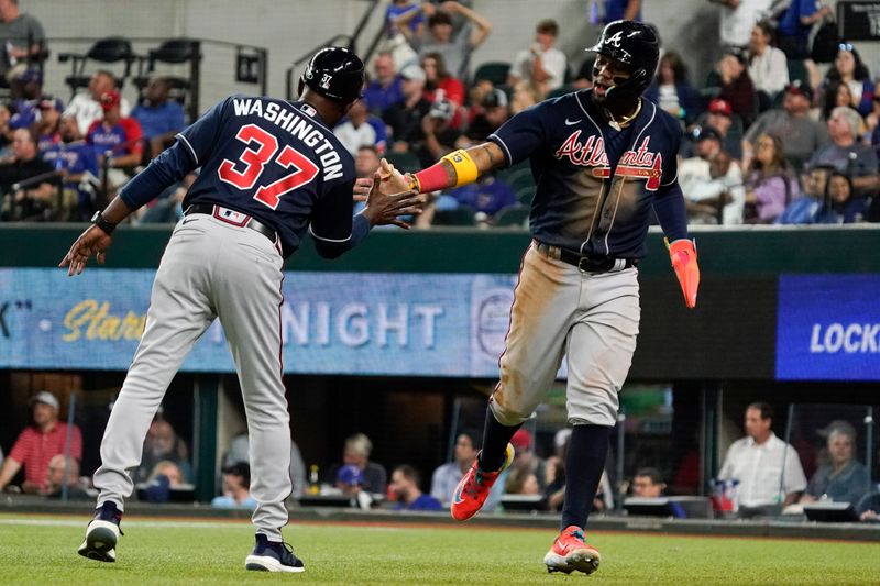 May 17, 2023; Arlington, Texas, USA; Atlanta Braves right fielder Ronald Acuna Jr. (13)  celebrates with third base coach Ron Washington (37) after scoring against the Texas Rangers during the eighth inning at Globe Life Field. Mandatory Credit: Raymond Carlin III-USA TODAY Sports