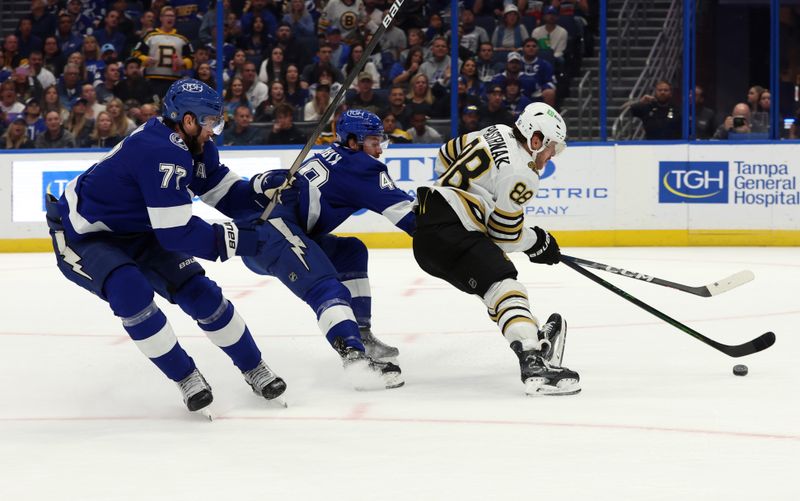 Nov 20, 2023; Tampa, Florida, USA; Tampa Bay Lightning defenseman Victor Hedman (77) and defenseman Nick Perbix (48) defends Boston Bruins right wing David Pastrnak (88) during the second period at Amalie Arena. Mandatory Credit: Kim Klement Neitzel-USA TODAY Sports