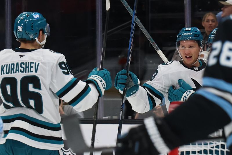 Oct 17, 2025; Salt Lake City, Utah, USA; San Jose Sharks left wing Jeff Skinner (right) celebrates scoring a goal against the Utah Mammoth with center Philipp Kurashev (96) during the second period at Delta Center. Mandatory Credit: Rob Gray-Imagn Images