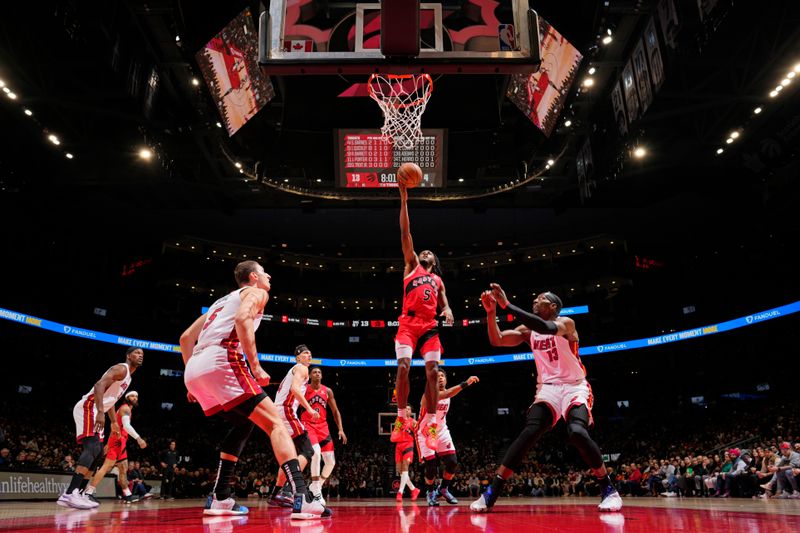 TORONTO, CANADA - JANUARY 17: Immanuel Quickley #5 of the Toronto Raptors drives to the basket during the game against the Miami Heat on January 17, 2024 at the Scotiabank Arena in Toronto, Ontario, Canada.  NOTE TO USER: User expressly acknowledges and agrees that, by downloading and or using this Photograph, user is consenting to the terms and conditions of the Getty Images License Agreement.  Mandatory Copyright Notice: Copyright 2024 NBAE (Photo by Mark Blinch/NBAE via Getty Images)