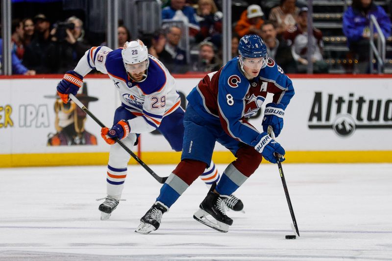 Jan 16, 2025; Denver, Colorado, USA; Colorado Avalanche defenseman Cale Makar (8) controls the puck ahead of Edmonton Oilers center Leon Draisaitl (29) in the second period at Ball Arena. Mandatory Credit: Isaiah J. Downing-Imagn Images