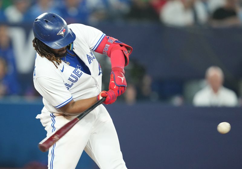 Jun 28, 2023; Toronto, Ontario, CAN; Toronto Blue Jays first baseman Vladimir Guerrero Jr. (27) hits a double against the San Francisco Giants during the eighth inning at Rogers Centre. Mandatory Credit: Nick Turchiaro-USA TODAY Sports