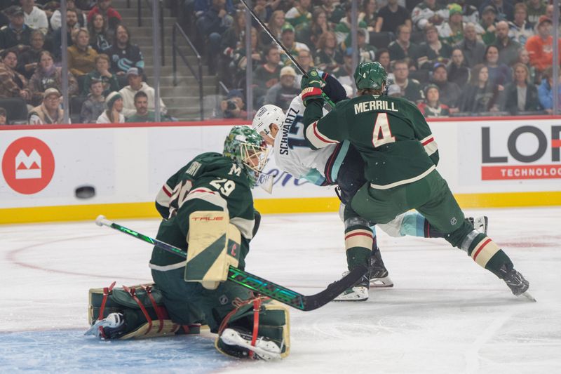 Oct 12, 2024; Saint Paul, Minnesota, USA; Minnesota Wild goaltender Marc-Andre Fleury (29) makes a save as defenseman Jon Merrill (4) covers Seattle Kraken left wing Tye Kartye (12) in the first period at Xcel Energy Center. Mandatory Credit: Matt Blewett-Imagn Images