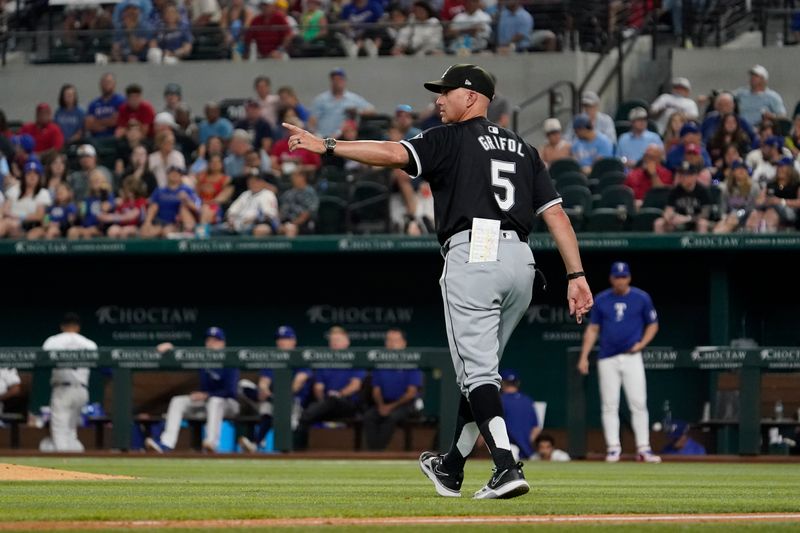 Jul 22, 2024; Arlington, Texas, USA; Chicago White Sox manager Pedro Grifol (5) walks to the mound to make a pitching change during the seventh inning against the Texas Rangers  at Globe Life Field. Mandatory Credit: Raymond Carlin III-USA TODAY Sports