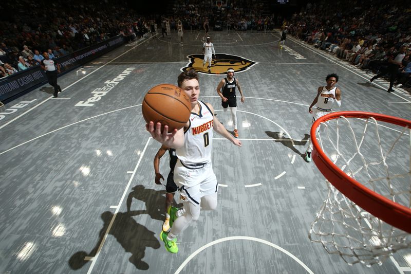 MEMPHIS, TN - APRIL 14: Christian Braun #0 of the Denver Nuggets drives to the basket during the game against the Memphis Grizzlies on April 14, 2024 at FedExForum in Memphis, Tennessee. NOTE TO USER: User expressly acknowledges and agrees that, by downloading and or using this photograph, User is consenting to the terms and conditions of the Getty Images License Agreement. Mandatory Copyright Notice: Copyright 2024 NBAE (Photo by Joe Murphy/NBAE via Getty Images)