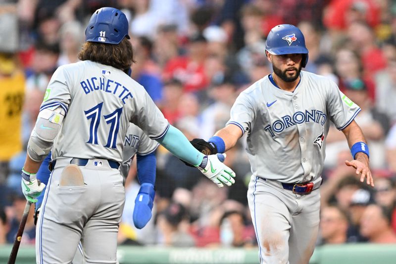 Jun 25, 2024; Boston, Massachusetts, USA; Toronto Blue Jays third baseman Isiah Kiner-Falefa (7) high-fives shortstop Bo Bichette (11) after scoring a run against the Boston Red Sox during the third inning at Fenway Park. Mandatory Credit: Brian Fluharty-USA TODAY Sports