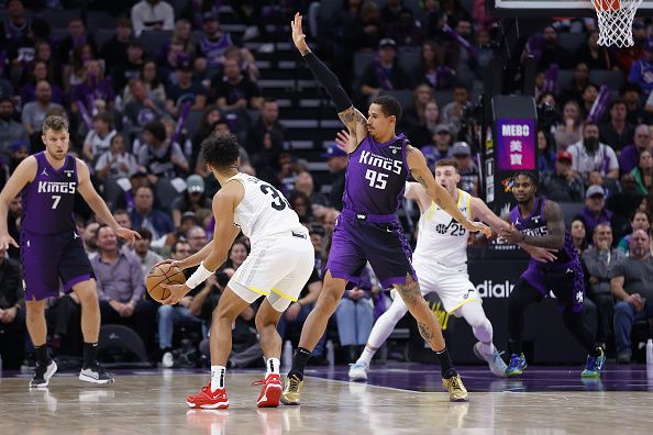 SACRAMENTO, CALIFORNIA - DECEMBER 16: Johnny Juzang #33 of the Utah Jazz is guarded by Juan Toscano-Anderson #95 of the Sacramento Kings in the fourth quarter at Golden 1 Center on December 16, 2023 in Sacramento, California. NOTE TO USER: User expressly acknowledges and agrees that, by downloading and or using this photograph, User is consenting to the terms and conditions of the Getty Images License Agreement. (Photo by Lachlan Cunningham/Getty Images)