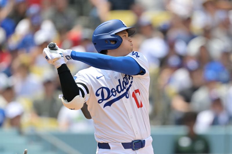 May 18, 2025; Los Angeles, California, USA; Los Angeles Dodgers two-way player Shohei Ohtani (17) hits a single in the third inning against the Los Angeles Angels at Dodger Stadium. Mandatory Credit: Jayne Kamin-Oncea-Imagn Images