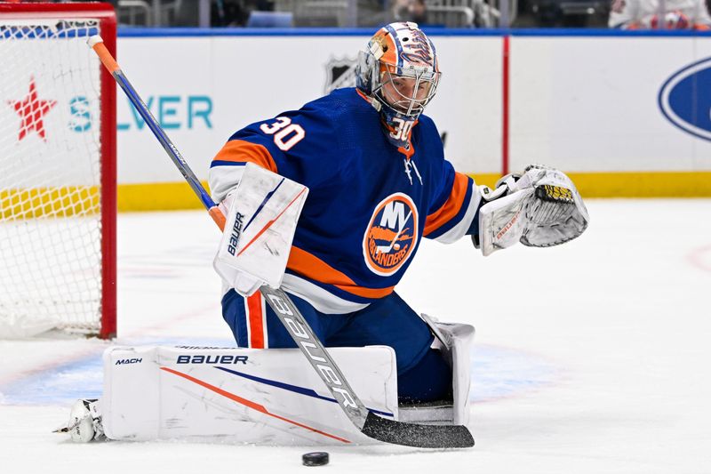 Feb 13, 2024; Elmont, New York, USA; New York Islanders goaltender Ilya Sorokin (30) makes a save against the Seattle Kraken during the first period at UBS Arena. Mandatory Credit: Dennis Schneidler-USA TODAY Sports