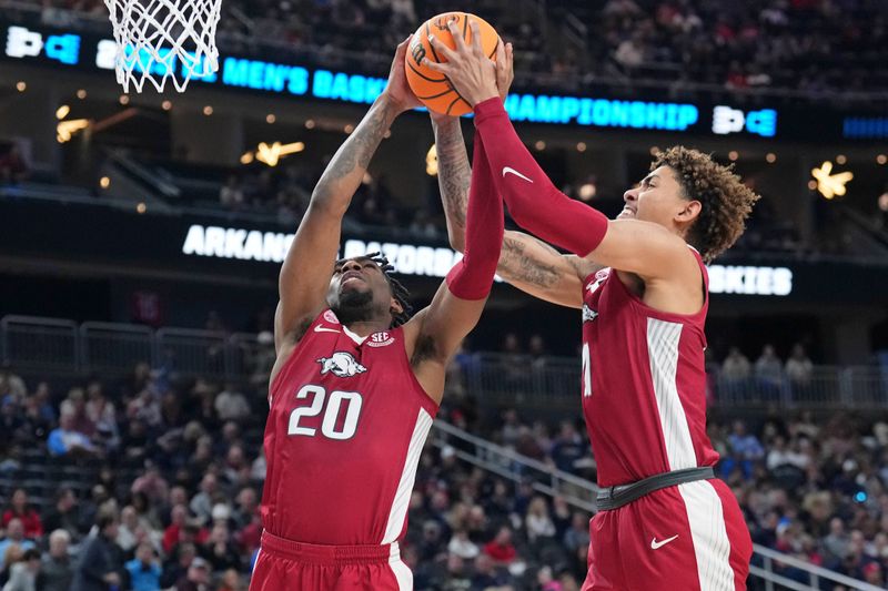 Mar 23, 2023; Las Vegas, NV, USA; Arkansas Razorbacks guard Anthony Black (0) and forward Jalen Graham (right) reach for the ball against the UConn Huskies during the second half at T-Mobile Arena. Mandatory Credit: Joe Camporeale-USA TODAY Sports