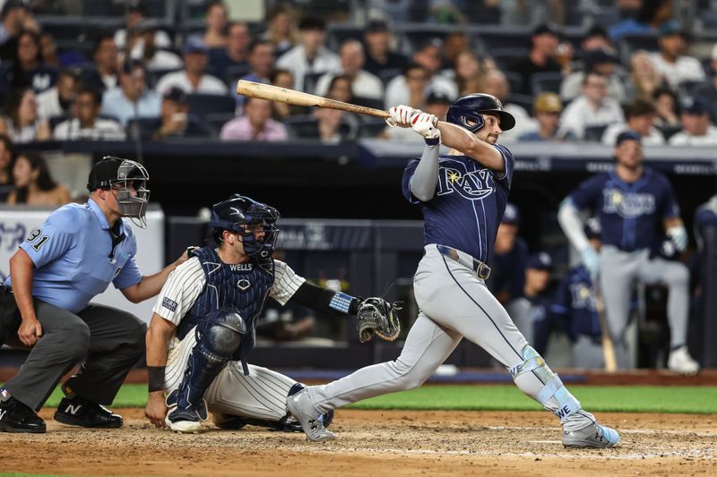 Jul 19, 2024; Bronx, New York, USA;  Tampa Bay Rays right fielder Josh Lowe (15) hits a solo home run in the sixth inning against the New York Yankees at Yankee Stadium. Mandatory Credit: Wendell Cruz-USA TODAY Sports