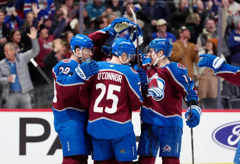 Jan 14, 2025; Denver, Colorado, USA; Members of the Colorado Avalanche celebrate a overtime win against the New York Rangers at Ball Arena. Mandatory Credit: Ron Chenoy-Imagn Images