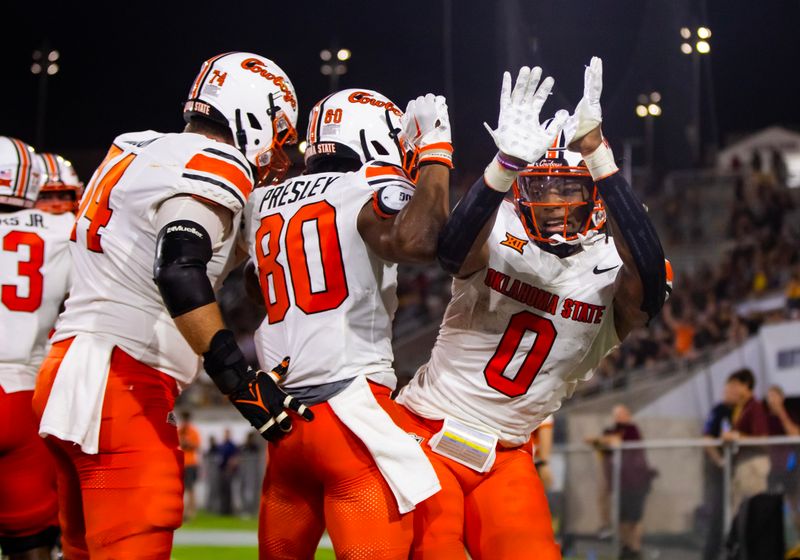 Sep 9, 2023; Tempe, Arizona, USA; Oklahoma State Cowboys wide receiver Brennan Presley (80) celebrates with running back Ollie Gordon II (0) after scoring a touchdown against the Arizona State Sun Devils in the second half at Mountain America Stadium. Mandatory Credit: Mark J. Rebilas-USA TODAY Sports