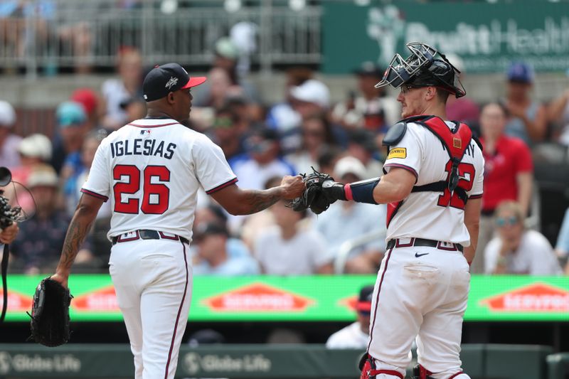 Jun 29, 2025; Cumberland, Georgia, Atlanta Braves relief pitcher Raisel Iglesias (26) and Atlanta Braves catcher Sean Murphy (12) fist bump during a game against the Philadelphia Phillies during the ninth inning at Truist Park. Mandatory Credit: Mady Mertens-Imagn Images