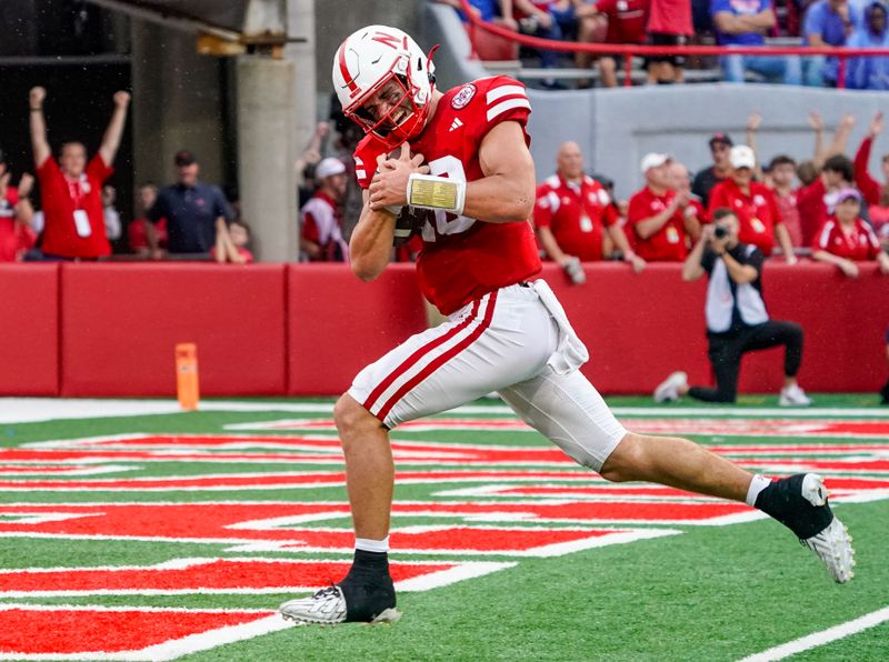 Sep 23, 2023; Lincoln, Nebraska, USA; Nebraska Cornhuskers quarterback Heinrich Haarberg (10) runs for a touchdown against the Louisiana Tech Bulldogs during the fourth quarter at Memorial Stadium. Mandatory Credit: Dylan Widger-USA TODAY Sports