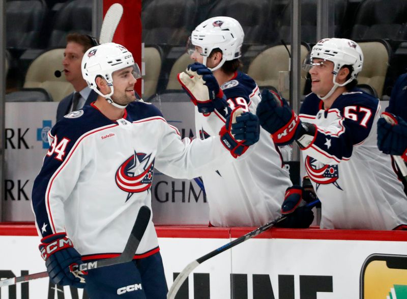 Oct 4, 2024; Pittsburgh, Pennsylvania, USA;  Columbus Blue Jackets defenseman Cole Clayton (34) celebrates his goal with the Columbus Blue Jackets bench against the Pittsburgh Penguins during the first period at PPG Paints Arena. Mandatory Credit: Charles LeClaire-Imagn Images