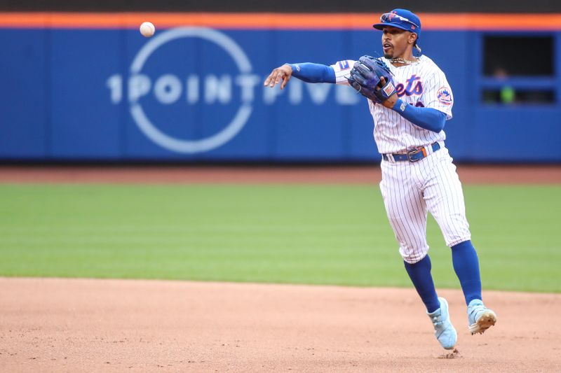 Jun 3, 2023; New York City, New York, USA;  New York Mets shortstop Francisco Lindor (12) makes a running throw to first base in the fourth inning against the Toronto Blue Jays at Citi Field. Mandatory Credit: Wendell Cruz-USA TODAY Sports