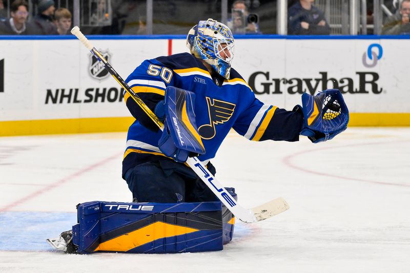 Nov 5, 2024; St. Louis, Missouri, USA;  St. Louis Blues goaltender Jordan Binnington (50) makes a glove save against the Tampa Bay Lightning during the third period at Enterprise Center. Mandatory Credit: Jeff Curry-Imagn Images