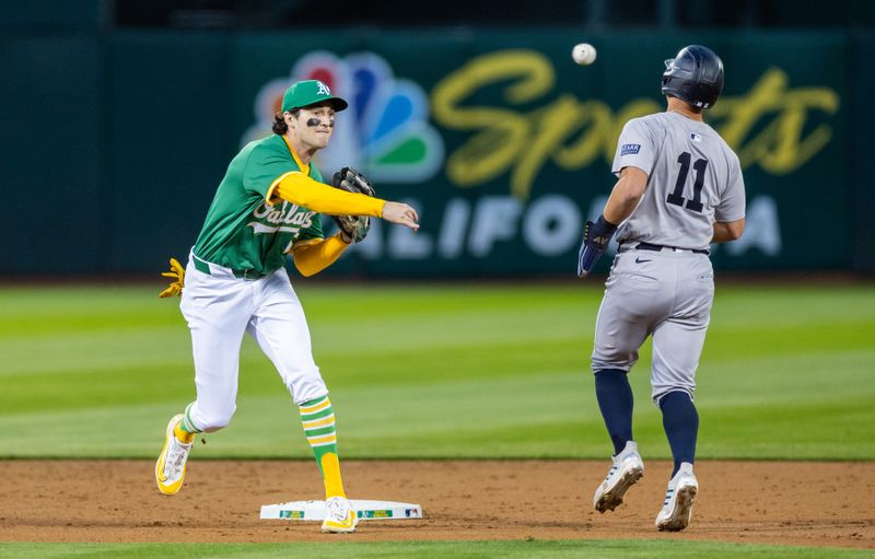 Sep 20, 2024; Oakland, California, USA; Oakland Athletics shortstop Jacob Wilson (5) turns a double play during the third inning against the New York Yankees at Oakland-Alameda County Coliseum. Mandatory Credit: Bob Kupbens-Imagn Images