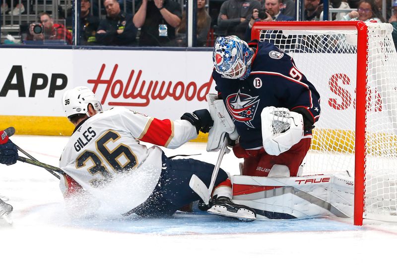 Oct 15, 2024; Columbus, Ohio, USA; Florida Panthers right wing Patrick Giles (36) slides into Columbus Blue Jackets goalie Elvis Merzlikins (90)after taking a shot during the third period at Nationwide Arena. Mandatory Credit: Russell LaBounty-Imagn Images