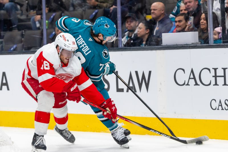 Nov 18, 2024; San Jose, California, USA; Detroit Red Wings center Andrew Copp (18) and San Jose Sharks center Tyler Toffoli (73) fight for the puck during the third period at SAP Center at San Jose. Mandatory Credit: Bob Kupbens-Imagn Images