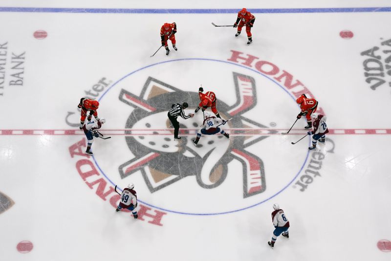 Apr 13, 2025; Anaheim, California, USA; NHL linesman Libor Suchanek (60) drops the puck on a faceoff between Colorado Avalanche defenseman Jack Ahcan (16) and Anaheim Ducks center Leo Carlsson (91) in the second period at Honda Center. Mandatory Credit: Kirby Lee-Imagn Images