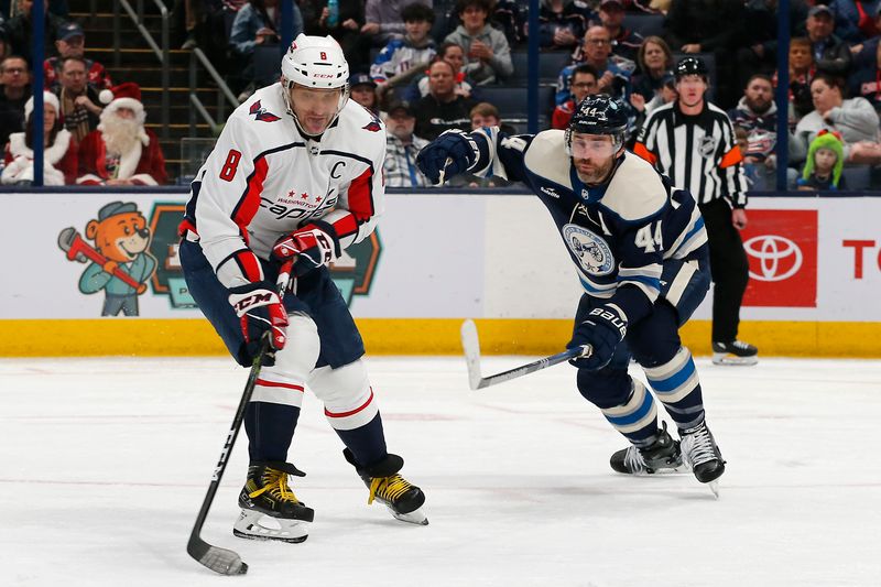 Dec 21, 2023; Columbus, Ohio, USA; Washington Capitals left wing Alex Ovechkin (8) wrists a shot on goal as Columbus Blue Jackets defenseman Erik Gudbranson (44) during the second period at Nationwide Arena. Mandatory Credit: Russell LaBounty-USA TODAY Sports