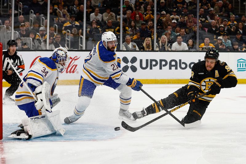 Oct 11, 2025; Boston, Massachusetts, USA; Boston Bruins right wing David Pastrnak (88) gets off a shot on Buffalo Sabres goaltender Alex Lyon (34) as defenseman Conor Timmins (21) defends during the first period at TD Garden. Mandatory Credit: Winslow Townson-Imagn Images