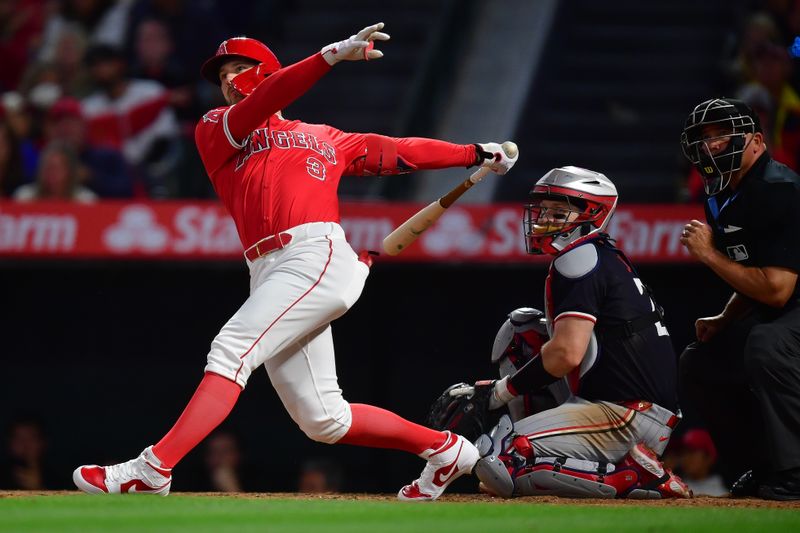 Apr 27, 2024; Anaheim, California, USA; Los Angeles Angels left fielder Taylor Ward (3) hits a ground rule double against the Minnesota Twins during the third inning at Angel Stadium. Mandatory Credit: Gary A. Vasquez-USA TODAY Sports