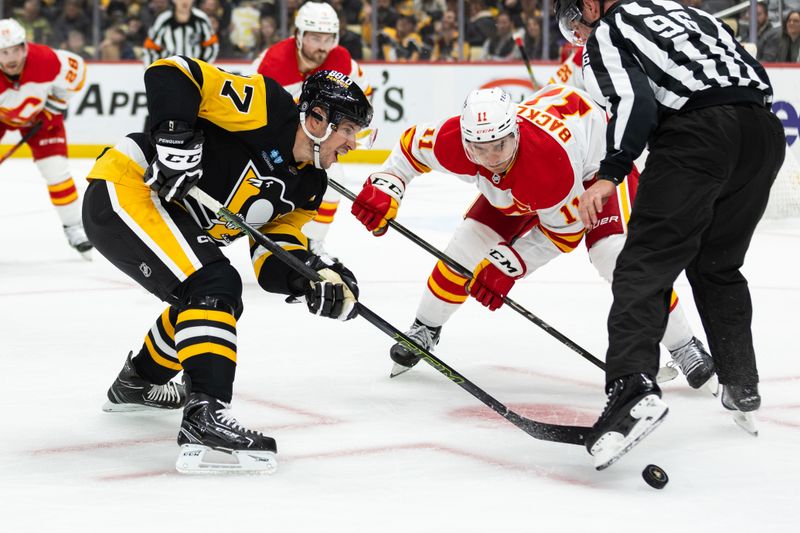 Oct 14, 2023; Pittsburgh, Pennsylvania, USA; Pittsburgh Penguins center Sidney Crosby (87) wins a face-off against Calgary Flames center Mikael Backlund (11) during the first period at PPG Paints Arena. Mandatory Credit: Scott Galvin-USA TODAY Sports