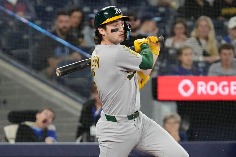 Jun 1, 2025; Toronto, Ontario, CAN; Oakland Athletics shortstop Jacob Wilson (5) hits a single against the Toronto Blue Jays during the first inning at Rogers Centre. Mandatory Credit: John E. Sokolowski-Imagn Images